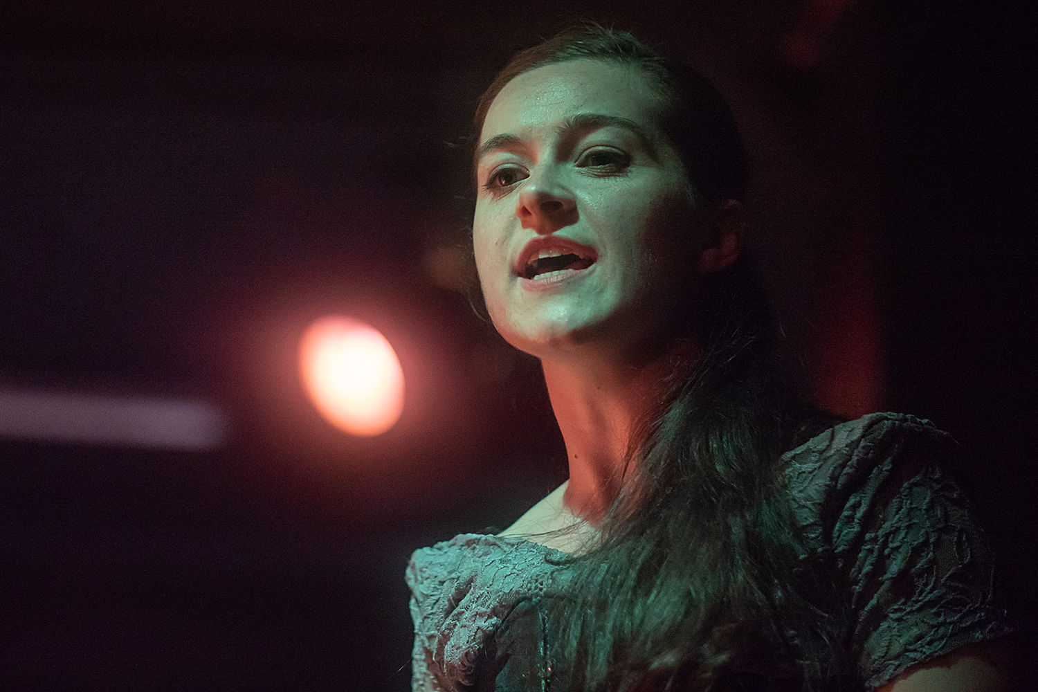 A white woman in gray dress looking severe.
